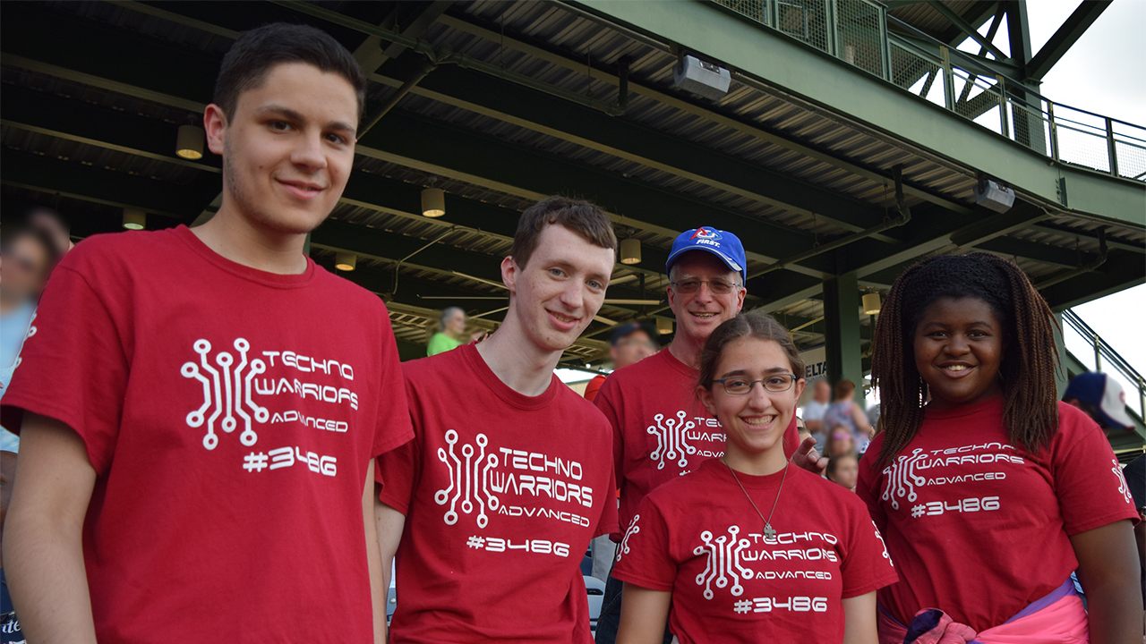 Jeff Lanum (in background) with Techno Warriors Advanced team members (from left) Jeremiah Theisen, Owen Lanum, Mary Jansen and Tamia White.
